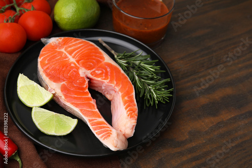 Fresh fish, products and marinade on wooden table, closeup. Space for text