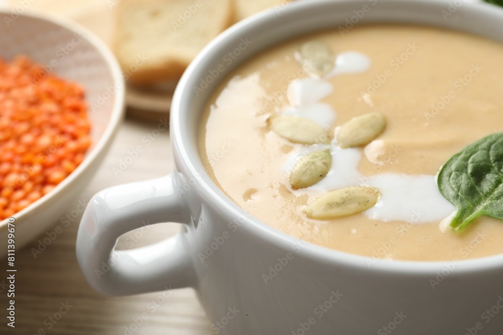 Healthy cream soup high in vegetable fats on wooden table, closeup Healthy cream soup high in vegetable fats on wooden table, closeup