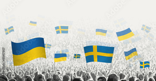 People waving flag of Sweden and Ukraine, symbolizing Sweden solidarity for Ukraine.