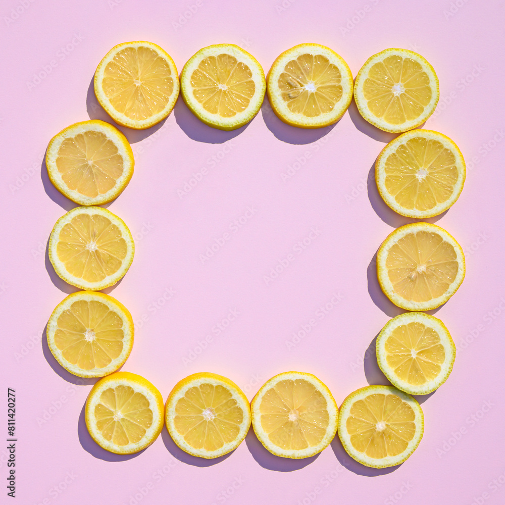 Sliced lemons on a pink background with copy space. Summer creative layout. Sliced lemons on a pink background with copy space. Summer creative layout.