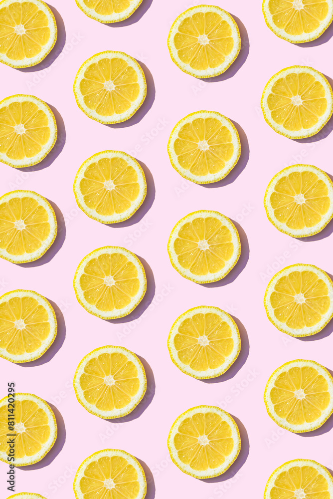 Pattern made of lemon fruit. Summer aesthetic pink background concept.
