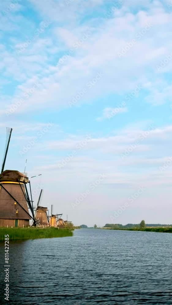 Netherlands rural village scenic view - windmills at famous tourist site Kinderdijk in Holland. Kinderdijk , Netherlands. Camera pan Netherlands rural village scenic view - windmills at famous tourist site Kinderdijk in Holland. Kinderdijk , Netherlands. Camera pan