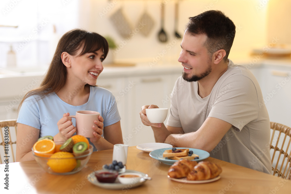 Happy couple having tasty breakfast at home Happy couple having tasty breakfast at home