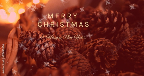 Pine cones resting on surface, surrounded by warm lights, convey holiday greetings