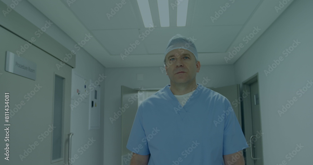 A middle-aged Caucasian male, doctor, standing in a hallway A middle-aged Caucasian male, doctor, standing in a hallway