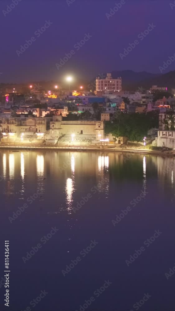Night view of famous indian hinduism pilgrimage town sacred holy hindu religious city Pushkar with Brahma temple, aarti ceremony, lake and ghats illuminated. Rajasthan, India. Horizontal pan Night view of famous indian hinduism pilgrimage town sacred holy hindu religious city Pushkar with Brahma temple, aarti ceremony, lake and ghats illuminated. Rajasthan, India. Horizontal pan
