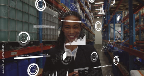 Image of loading bars and graphs over smiling biracial female manager in factory