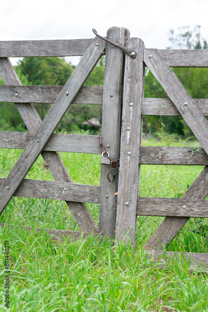 Weathered Wooden Gate and Rusty Chain of an Old Country Home
