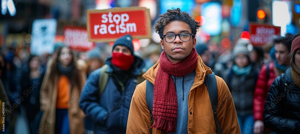 Fototapeta premium A man stands before a gathering, with the crowd at the rally voicing