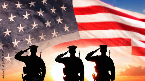 Silhouette of soldiers saluting against the background of the American flag