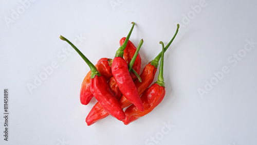 Photo of chilies stacked with white background.