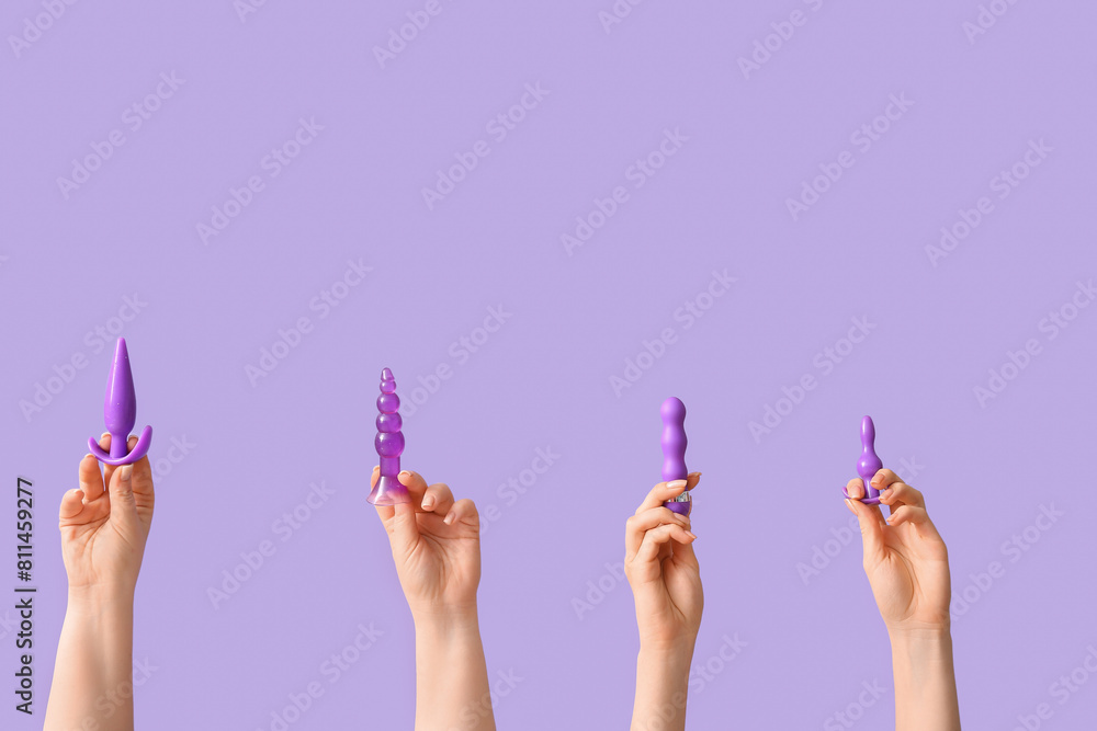 © Pixel-Shot - Female hands with anal plugs and vibrator on lilac background © Pixel-Shot - Female hands with anal plugs and vibrator on lilac background
