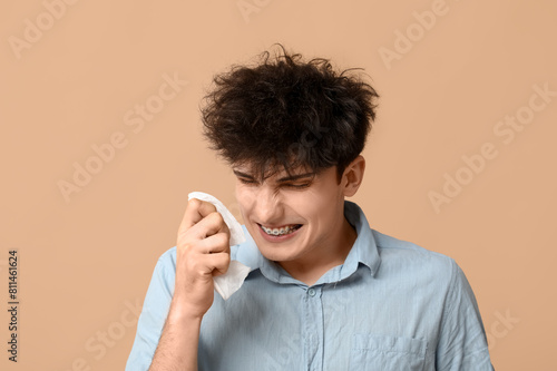 Young man with runny nose o...