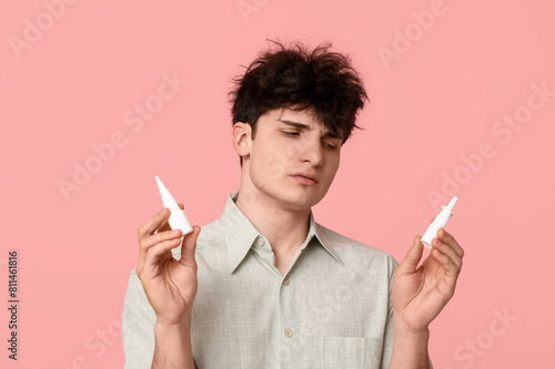Young man with nasal drops ...
