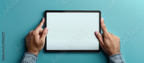 Close up of a man's hands holding a tablet with a blank screen and pointing finger on it, mockup banner for an online shopping website or mobile application design. photo
