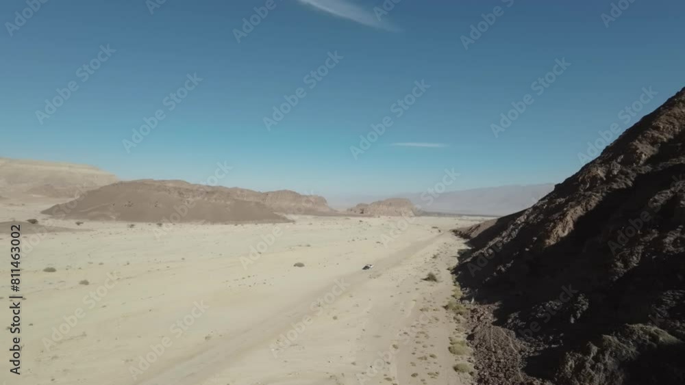 Aerial video in Timna Park above a vehicle traveling on a desert road. Israel Aerial video in Timna Park above a vehicle traveling on a desert road. Israel