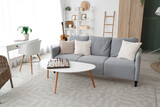 Interior of cozy living room with sofa and chess board on coffee table