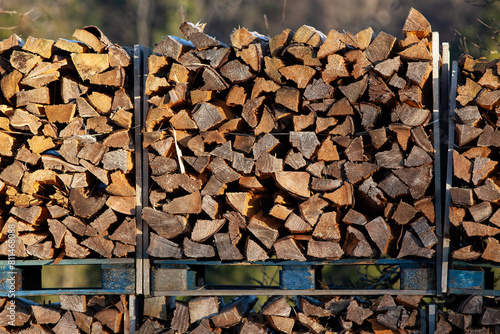 Firewood stacked - wood logs, background texture.





