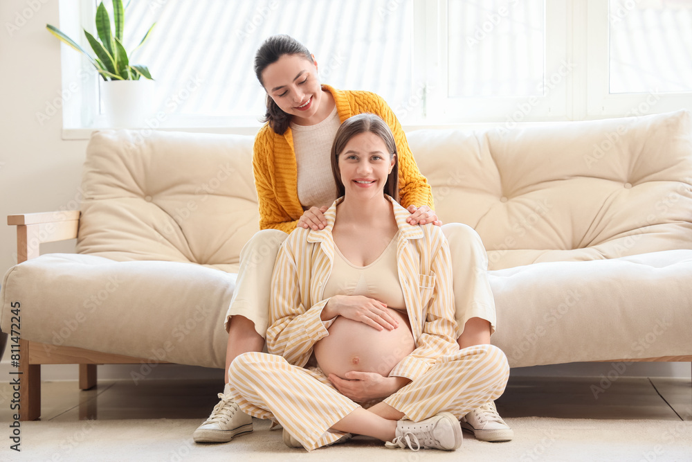 Young pregnant woman with doula sitting at home Young pregnant woman with doula sitting at home