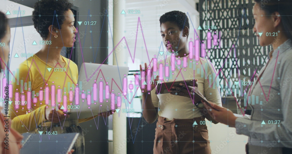 Obraz premium Image of multiple graphs with changing numbers, diverse female coworkers sharing ideas in office