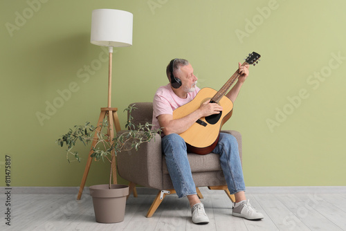 Mature man with headphones ...