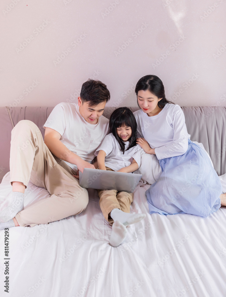 A family of three in the bed in the bedroom A family of three in the bed in the bedroom