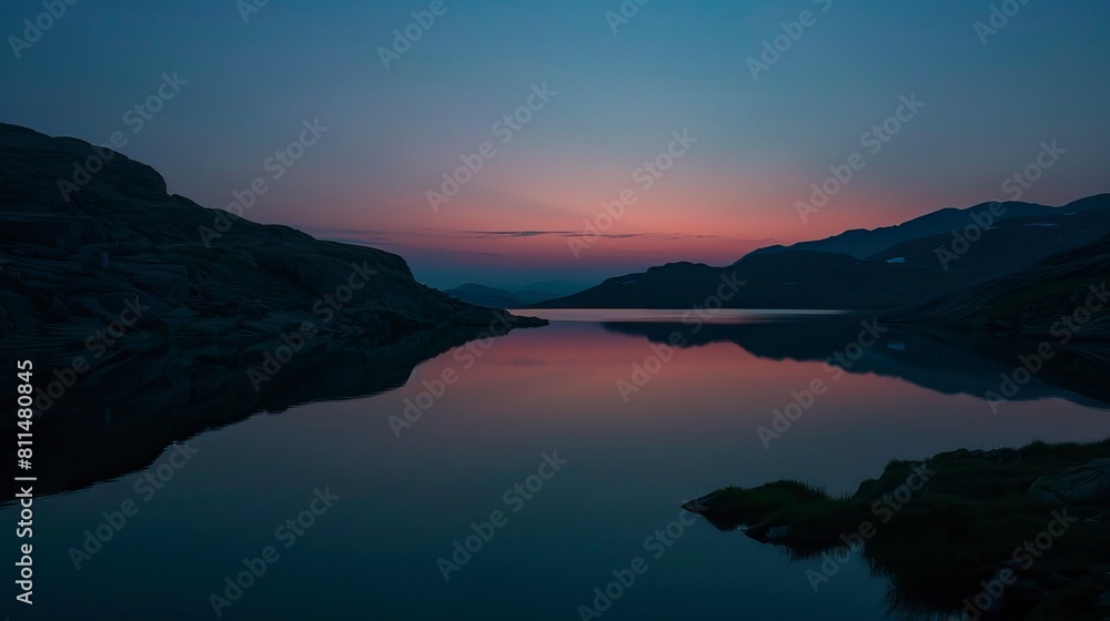 A lake in the mountains at the dawn of the sun A lake in the mountains at the dawn of the sun
