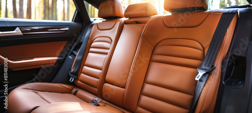 A high-end, luxurious front view of spacious brown leather back passenger seats in a sleek, modern, and stylish luxury car interior, showcasing comfort and elegance.