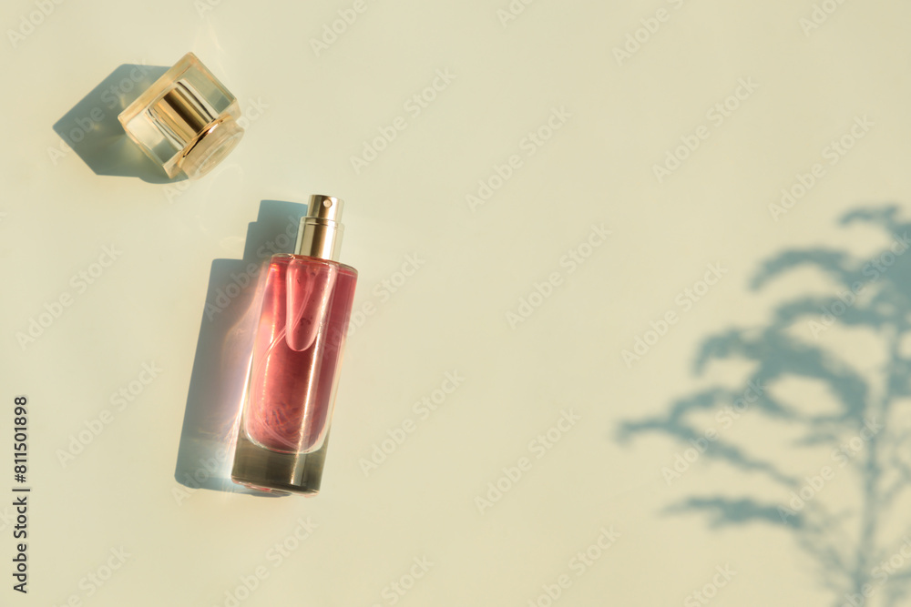 Perfume bottle on beige background, Glass bottle of perfumery Perfume bottle on beige background, Glass bottle of perfumery