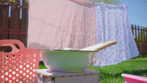 Washing clothes on old vintage washboard outdoors. Wide view of decoration