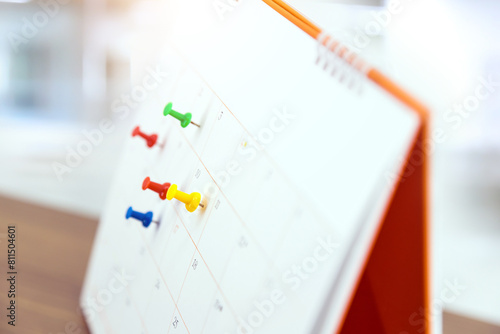 Pin on blank desk calendar in office workplace concept time management event planner or personal organization for business meeting and appointment reminder and schedule planning or holiday plan. © Eakrin