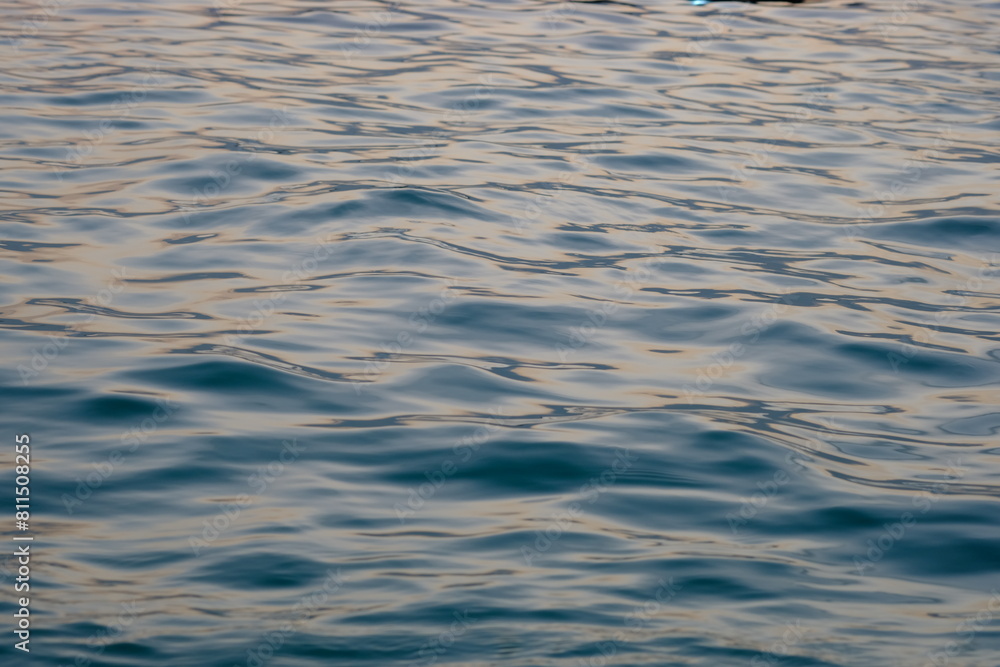 the surface of the sea water is blue. bluish water with calm wave ripples. the surface of the sea water is blue. bluish water with calm wave ripples.