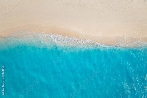Summer seascape beautiful closeup. Blue sea water in sunny day. Top view from drone. Sea aerial surf  amazing tropical nature background. Mediterranean bright sea bay waves splashing beach sandy coast