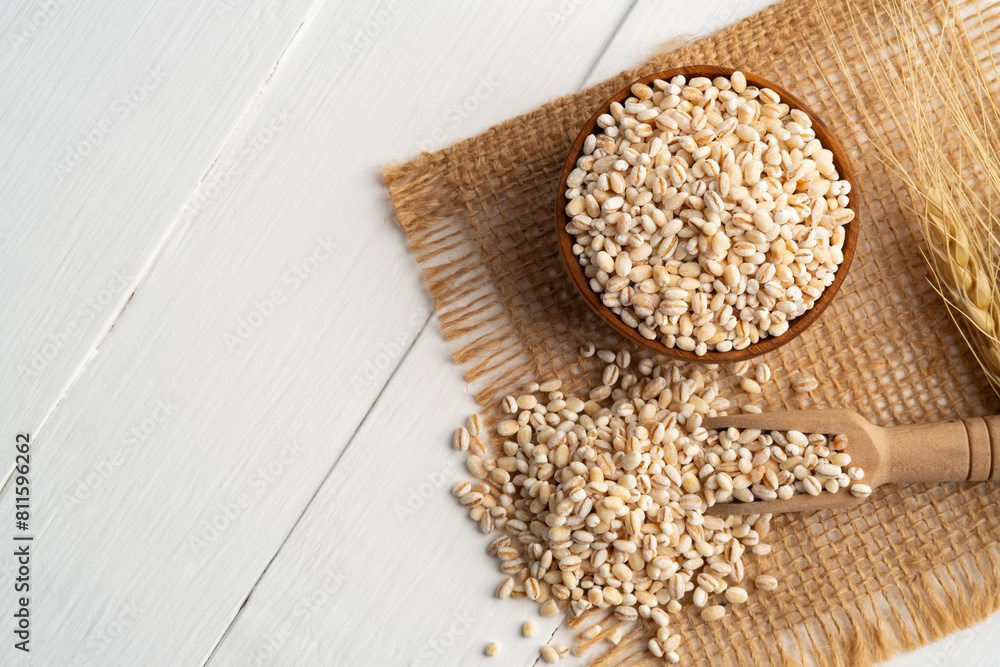 Uncooked barley, Heap of pearl barley on wooden table with copy space.Top view. Uncooked barley, Heap of pearl barley on wooden table with copy space.Top view.