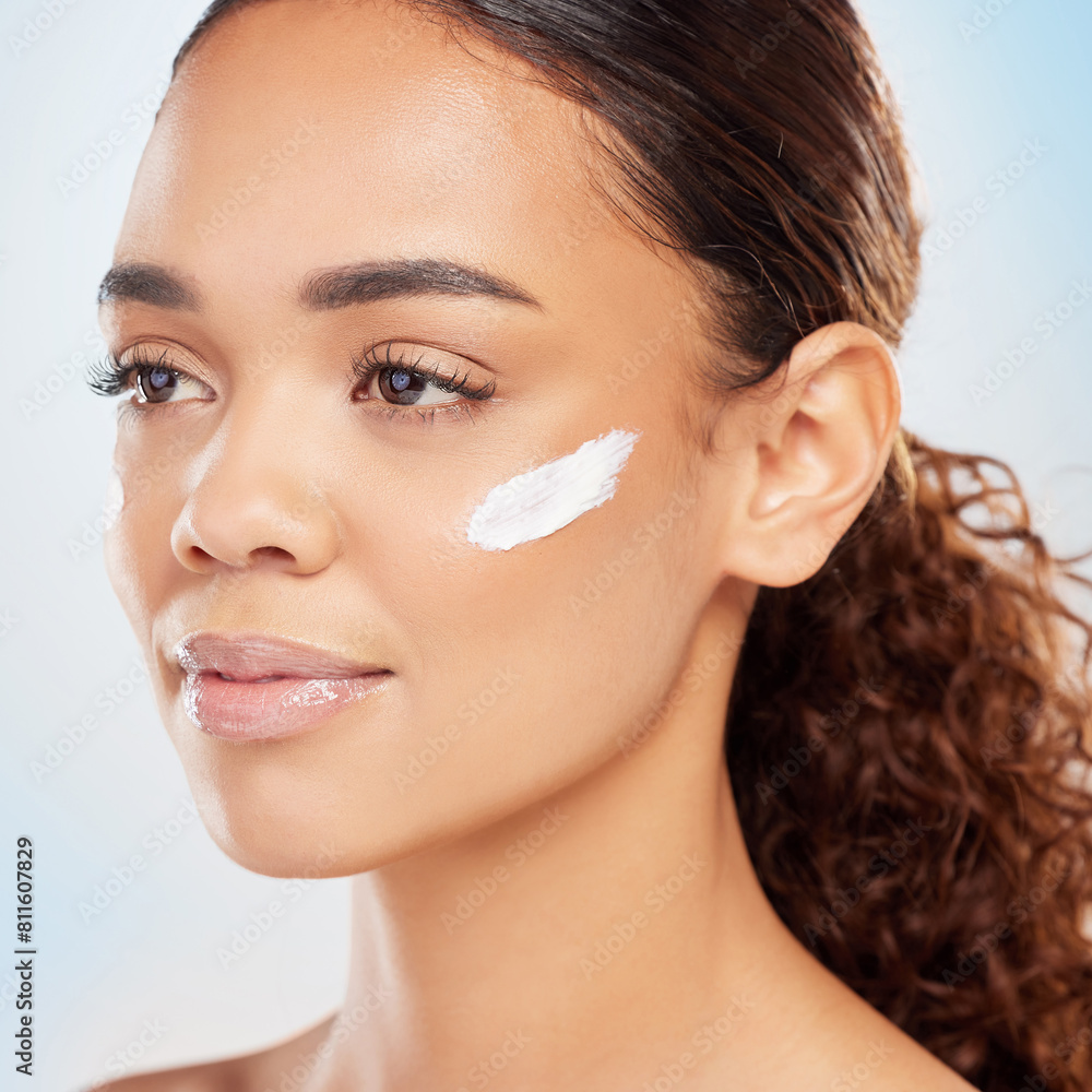 Skincare, product and woman with cream in studio for moisturizer, benefits and dermatology. Female person, lotion and smile with shine for collagen, morning routine and self care on blue background Skincare, product and woman with cream in studio for moisturizer, benefits and dermatology. Female person, lotion and smile with shine for collagen, morning routine and self care on blue background