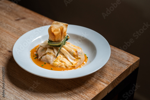 Photography plate of haute cuisine food, with fresh vegetables and fish, during an event in