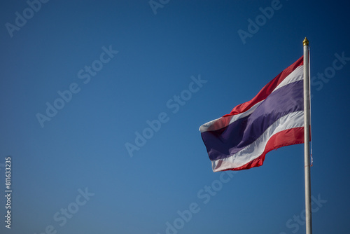 Flag of Thailand national against blue sky waving with pride colorful background