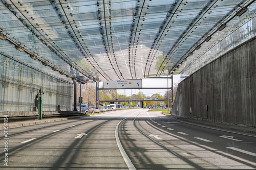 A four-lane road exiting the tunnel into the city. Automotive industry.