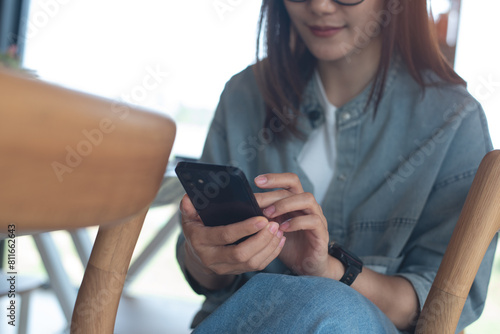 Happy woman using mobile phone at coffee shop, close up, online shopping, mobile banking, e-payment, social media networking, modern people lifestyle concept, smart devices