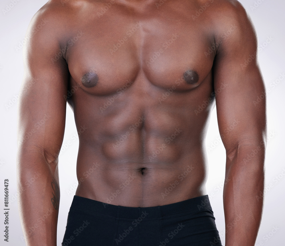 Fitness, black man and chest of bodybuilder in closeup for healthy body isolated in studio. Sports, male person or model and shirtless for strong muscles and weight loss routine from cardio.