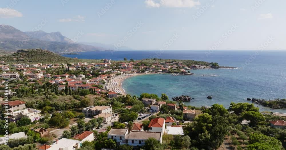 An aerial perspective of the serene Stoupa Beach in Kardamili, Greece capturing the clear blue waters, the sprawling shoreline, and the lush greenery surrounding the coastal area. An aerial perspective of the serene Stoupa Beach in Kardamili, Greece capturing the clear blue waters, the sprawling shoreline, and the lush greenery surrounding the coastal area.