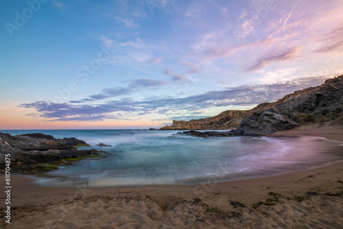 Sunset view of Minas Cove in the Cabo Cope and Puntas de Calnegre Regional Park, with crystal clear waters and colorful sky