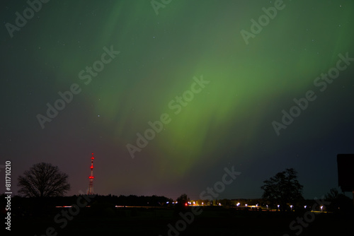 the northern lights above the outdoor terrace where the television tower can be seen in the distance