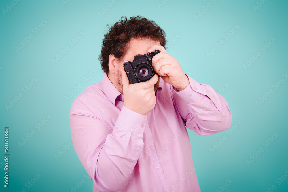 Vacations and holidays. Funny fat man dreams of traveling. Blue background. Vacations and holidays. Funny fat man dreams of traveling. Blue background.