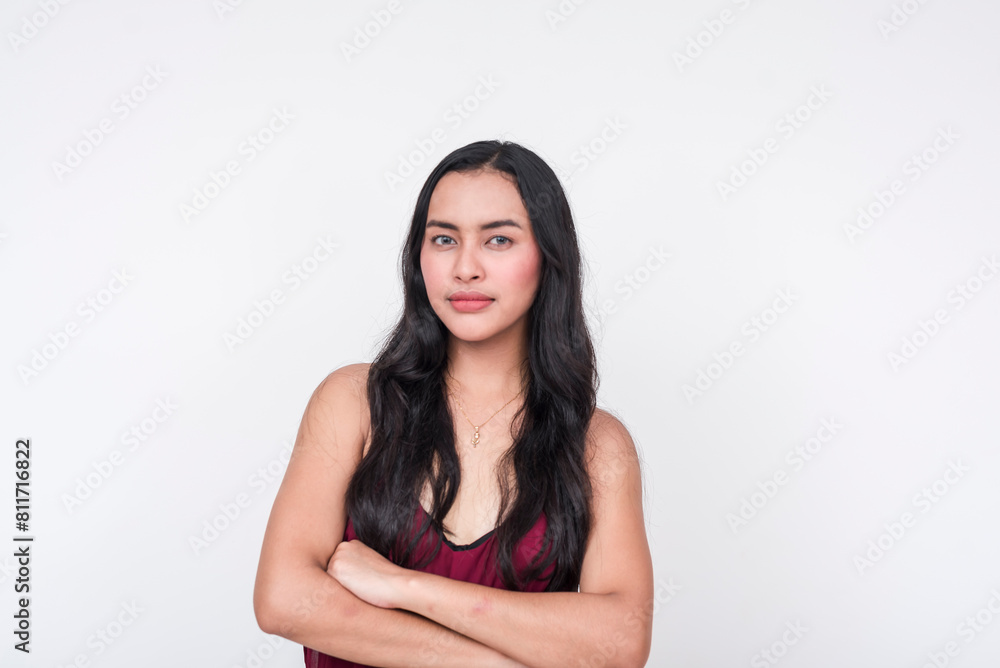 A young Asian woman dressed in a chic maroon dress looking pissed and angry, arms crossed. Isolated on a white background. A young Asian woman dressed in a chic maroon dress looking pissed and angry, arms crossed. Isolated on a white background.