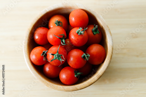 red cherry tomato on wooden background