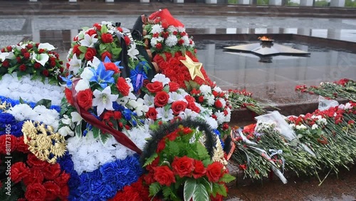 Wreaths and flowers against the backdrop of the eternal flame on Poklonnaya Hill in Moscow