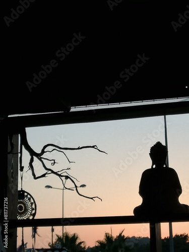 silhouette of a sculpture by thr sunset