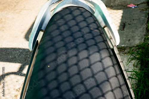 Fotografie A black motorcycle seat with a mesh pattern