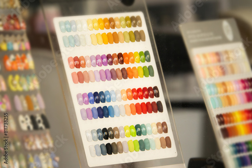 A colorful chart of nail polish colors is displayed in a store